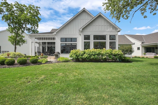 7211 Craigens Ct, Plain City, OH 43064 - rear view of property with board and batten siding, a lawn, and a patio area