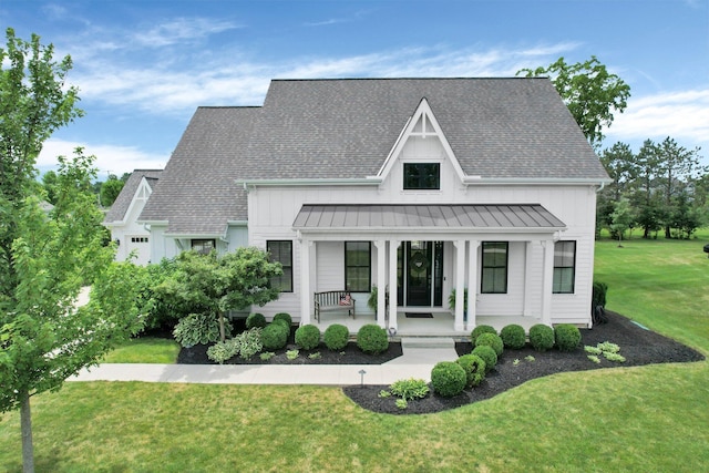 7211 Craigens Ct, Plain City, OH 43064 - view of front of house featuring a standing seam roof, a porch, roof with shingles, and a front yard