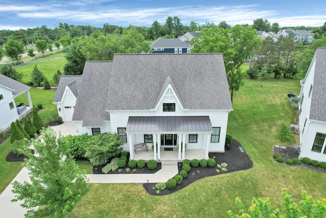 7211 Craigens Ct, Plain City, OH 43064 - view of front of property with a standing seam roof, a shingled roof, a metal roof, and a front lawn