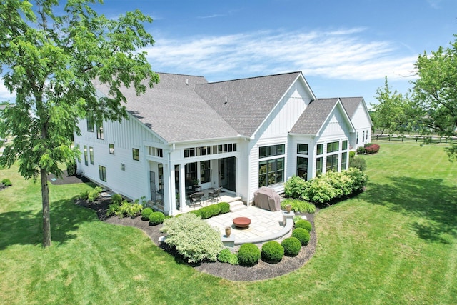 7211 Craigens Ct, Plain City, OH 43064 - rear view of property with a patio, a shingled roof, and board and batten siding