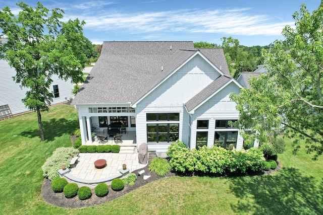 7211 Craigens Ct, Plain City, OH 43064 - back of house with roof with shingles, a yard, a patio, and board and batten siding