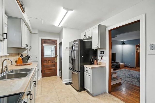 613 Salisbury Rd, Columbus, OH 43204 - kitchen featuring freestanding refrigerator, light countertops, and light tile patterned floors