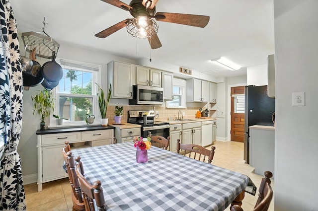 613 Salisbury Rd, Columbus, OH 43204 - dining space featuring light tile patterned flooring and ceiling fan