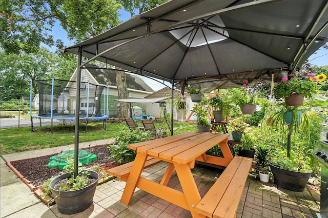 613 Salisbury Rd, Columbus, OH 43204 - view of patio featuring outdoor dining space, a trampoline, a storage unit, and a gazebo