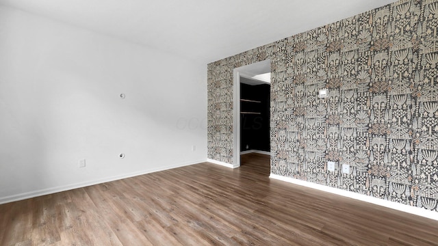 3099 Ambarwent Rd, Reynoldsburg, OH 43068 - unfurnished room with wood finished floors and an accent wall