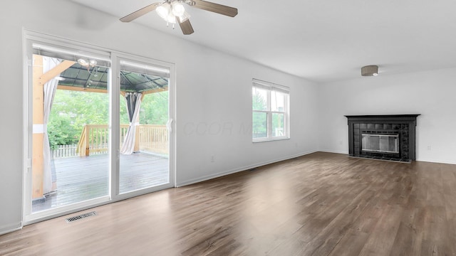 3099 Ambarwent Rd, Reynoldsburg, OH 43068 - unfurnished living room featuring wood finished floors, ceiling fan, and a glass covered fireplace