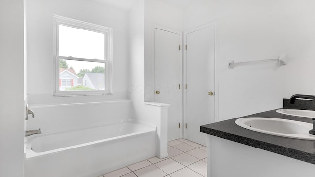 3099 Ambarwent Rd, Reynoldsburg, OH 43068 - bathroom featuring a garden tub, double vanity, and tile patterned floors