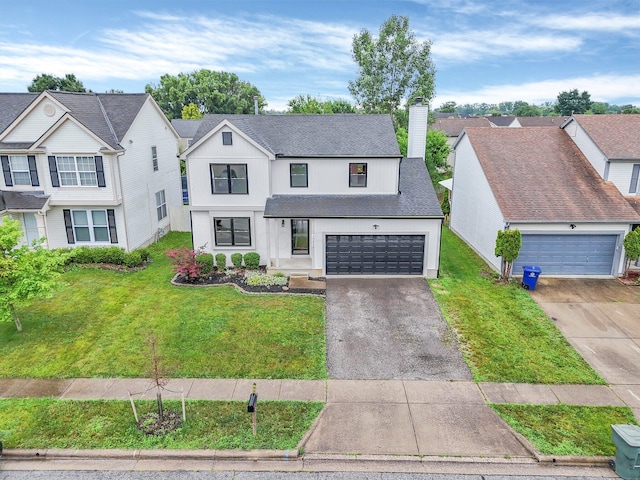 3099 Ambarwent Rd, Reynoldsburg, OH 43068 - view of front facade with asphalt driveway, roof with shingles, and a front lawn