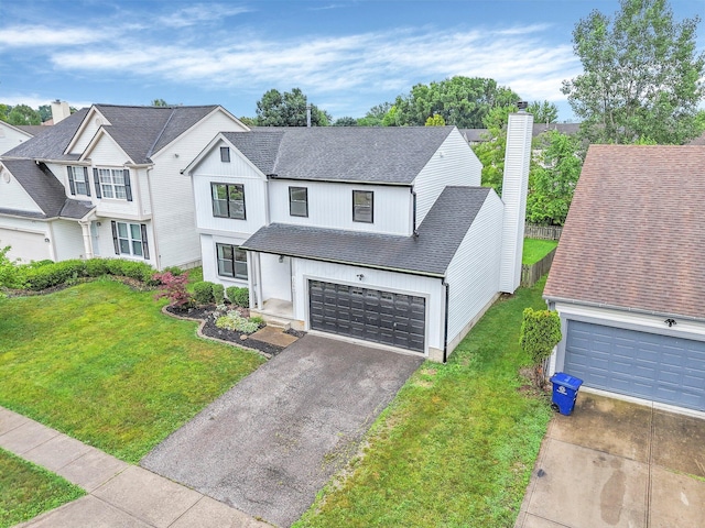 3099 Ambarwent Rd, Reynoldsburg, OH 43068 - view of front of house with asphalt driveway, roof with shingles, a front lawn, an attached garage, and a chimney