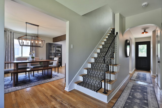 315 S Kellner Rd, Columbus, OH 43209 - foyer featuring arched walkways, hardwood / wood-style flooring, stairs, and a chandelier