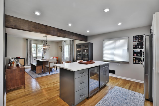 315 S Kellner Rd, Columbus, OH 43209 - kitchen featuring beverage cooler, gray cabinets, light countertops, light wood-type flooring, and a kitchen island