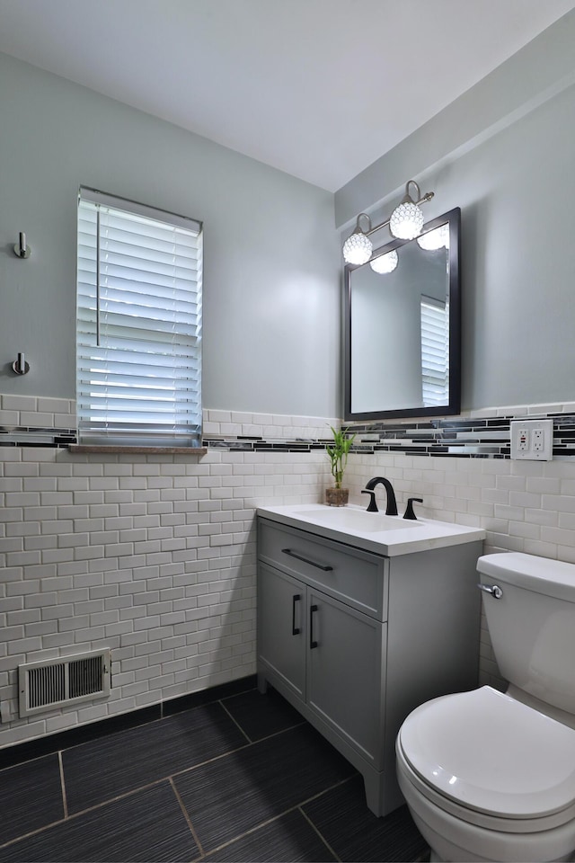 315 S Kellner Rd, Columbus, OH 43209 - bathroom featuring tile walls, tile patterned flooring, vanity, and a wainscoted wall