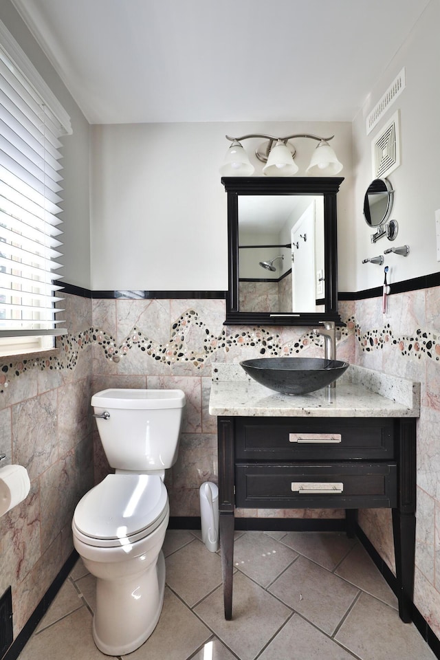 315 S Kellner Rd, Columbus, OH 43209 - bathroom featuring tile walls, tile patterned flooring, vanity, and wainscoting