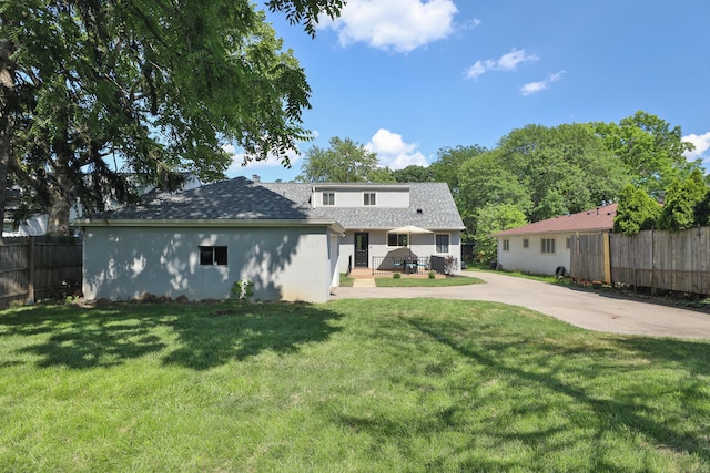 315 S Kellner Rd, Columbus, OH 43209 - rear view of property with driveway, a shingled roof, and stucco siding