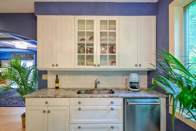 7394 Whitlind Ln, Athens, OH 45701 - bar with stainless steel dishwasher, decorative backsplash, and wood finished floors