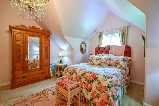 7394 Whitlind Ln, Athens, OH 45701 - bedroom with light wood-style flooring, a chandelier, and vaulted ceiling