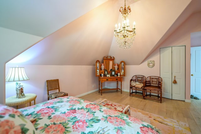 7394 Whitlind Ln, Athens, OH 45701 - bedroom with wood-type flooring, vaulted ceiling, a chandelier, and a closet