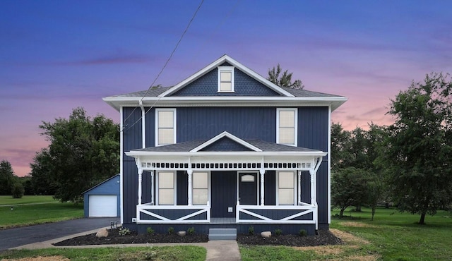 285 E Cherry St, Sunbury, OH 43074 - view of front facade featuring covered porch, a front yard, a detached garage, an outbuilding, and roof with shingles