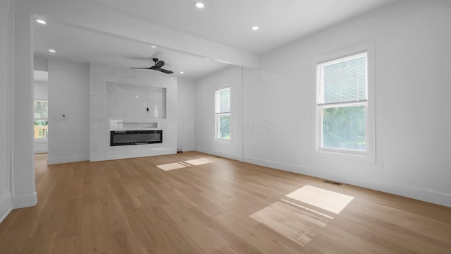 285 E Cherry St, Sunbury, OH 43074 - unfurnished living room featuring healthy amount of natural light, light wood-style floors, a tile fireplace, recessed lighting, and a ceiling fan