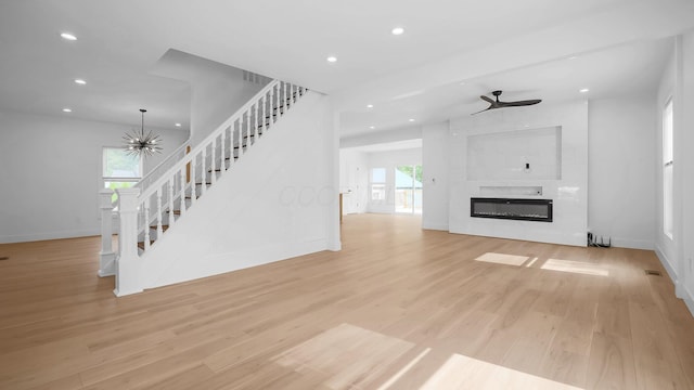 285 E Cherry St, Sunbury, OH 43074 - unfurnished living room with stairs, recessed lighting, light wood-style flooring, a ceiling fan, and a fireplace