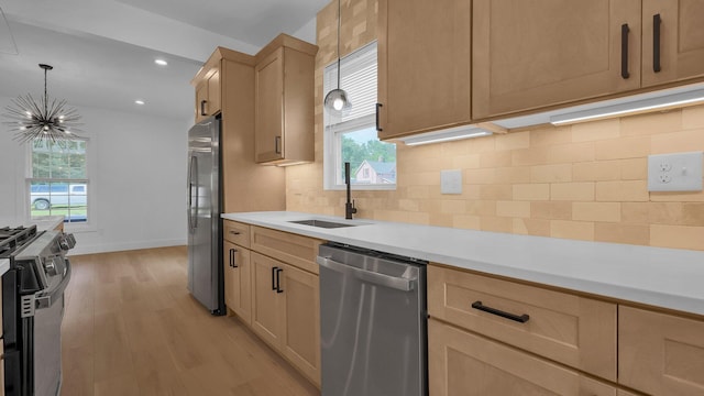 285 E Cherry St, Sunbury, OH 43074 - kitchen featuring stainless steel appliances, a chandelier, light brown cabinets, light wood-style flooring, and light countertops