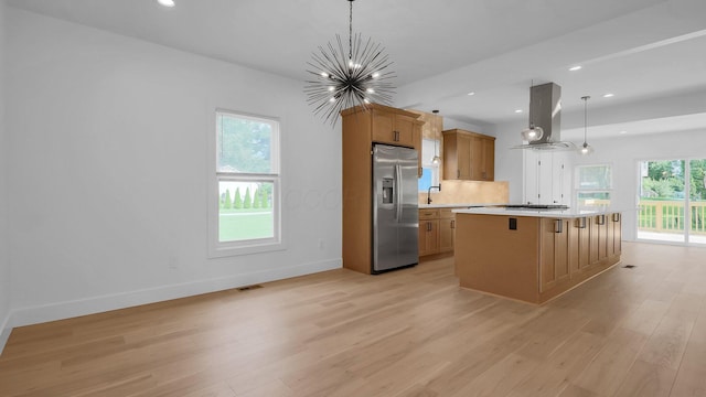 285 E Cherry St, Sunbury, OH 43074 - kitchen with stainless steel fridge with ice dispenser, island exhaust hood, a chandelier, light wood-style floors, and light countertops