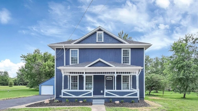 285 E Cherry St, Sunbury, OH 43074 - victorian-style house with covered porch, a front lawn, an outbuilding, a detached garage, and a shingled roof