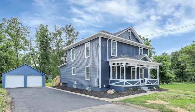 285 E Cherry St, Sunbury, OH 43074 - view of home's exterior with covered porch, a garage, an outbuilding, and a lawn