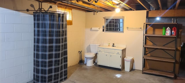 96 Summit St, Newark, OH 43055 - bathroom featuring concrete flooring, a shower with curtain, vanity, and concrete block wall