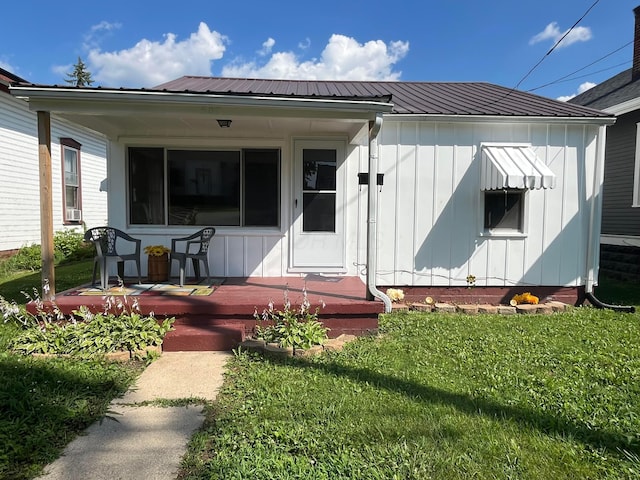 507 Broadway St, Washington Court House, OH 43160 - doorway to property featuring board and batten siding, covered porch, and a yard
