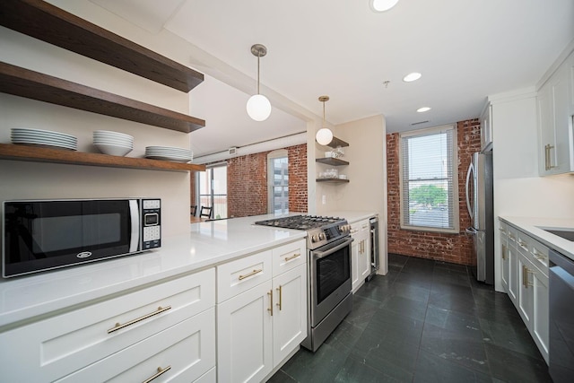 432 E Rich St Unit 3F, Columbus, OH 43215 - kitchen featuring open shelves, appliances with stainless steel finishes, brick wall, white cabinetry, and decorative light fixtures