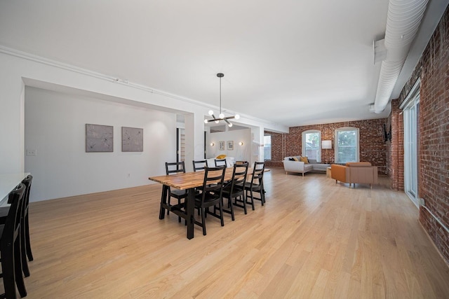 432 E Rich St Unit 3F, Columbus, OH 43215 - dining area featuring brick wall, light wood-type flooring, and a chandelier