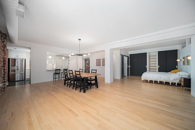 432 E Rich St Unit 3F, Columbus, OH 43215 - dining area featuring light wood-type flooring and a chandelier