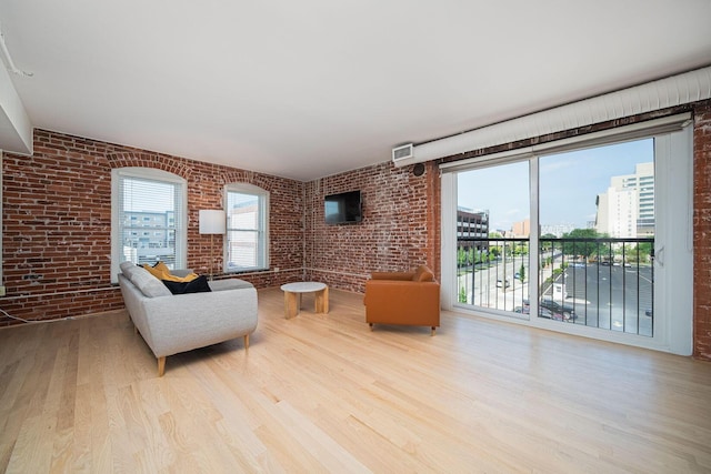 432 E Rich St Unit 3F, Columbus, OH 43215 - living room featuring brick wall and wood finished floors