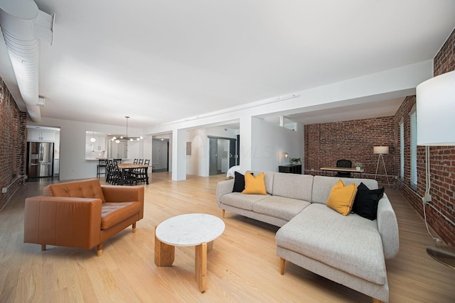 432 E Rich St Unit 3F, Columbus, OH 43215 - living area with brick wall, light wood-style flooring, and a fireplace