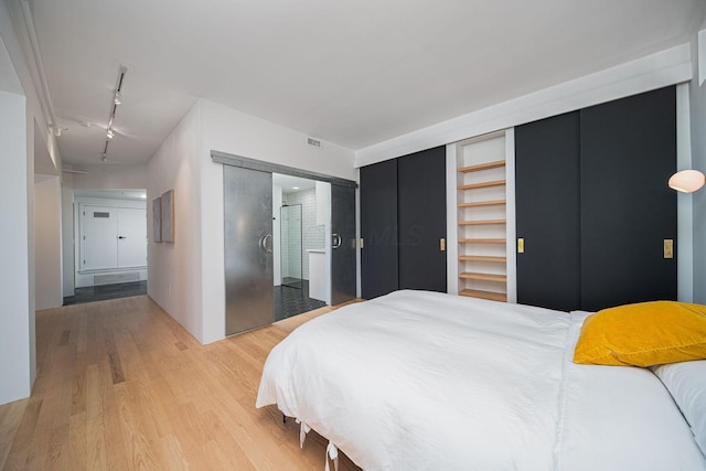 432 E Rich St Unit 3F, Columbus, OH 43215 - bedroom featuring rail lighting and light wood-style flooring