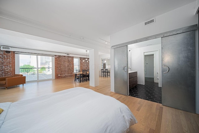 432 E Rich St Unit 3F, Columbus, OH 43215 - bedroom with wood finished floors and brick wall