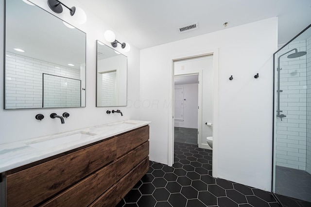 432 E Rich St Unit 3F, Columbus, OH 43215 - bathroom featuring double vanity, tiled shower, and tile patterned flooring
