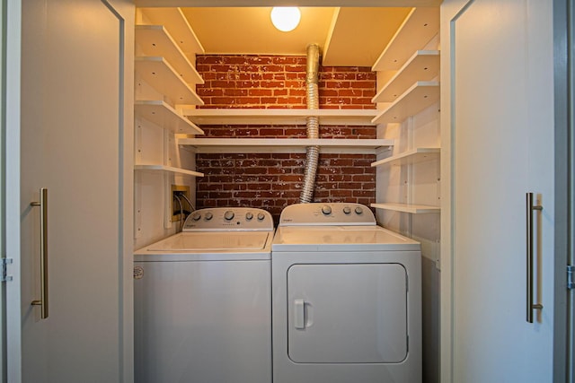 432 E Rich St Unit 3F, Columbus, OH 43215 - laundry room featuring washing machine and clothes dryer and brick wall