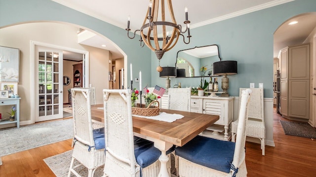 108 Hawks Cove Ct, Granville, OH 43023 - dining area with a chandelier, arched walkways, wood finished floors, and ornamental molding