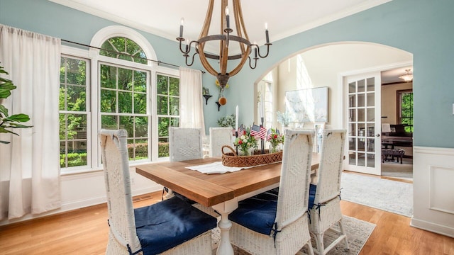 108 Hawks Cove Ct, Granville, OH 43023 - dining area with arched walkways, a chandelier, crown molding, and light wood-style flooring