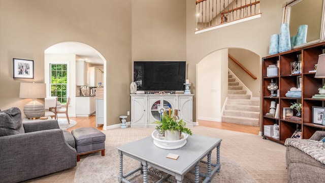 108 Hawks Cove Ct, Granville, OH 43023 - living area with a towering ceiling, arched walkways, and stairs