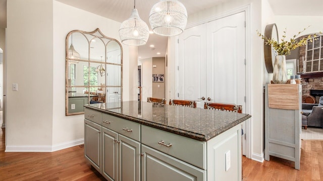 108 Hawks Cove Ct, Granville, OH 43023 - kitchen with gray cabinetry, light wood finished floors, a kitchen island, and healthy amount of natural light