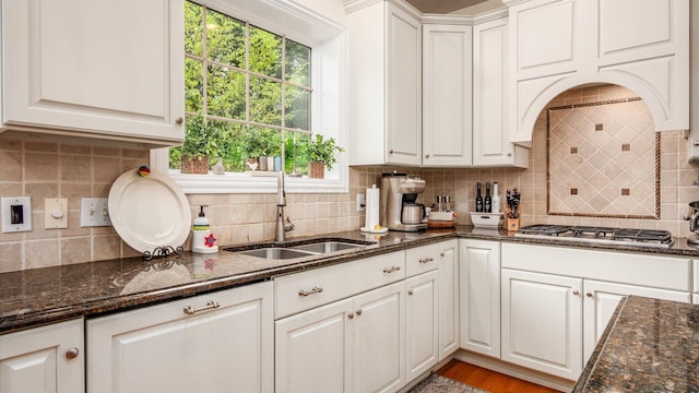 108 Hawks Cove Ct, Granville, OH 43023 - kitchen with backsplash, stainless steel gas stovetop, white cabinets, and healthy amount of natural light