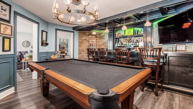 108 Hawks Cove Ct, Granville, OH 43023 - game room featuring a dry bar, wood finished floors, a chandelier, wainscoting, and brick wall