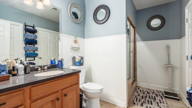 108 Hawks Cove Ct, Granville, OH 43023 - bathroom featuring wainscoting, an enclosed shower, vanity, and tile patterned floors