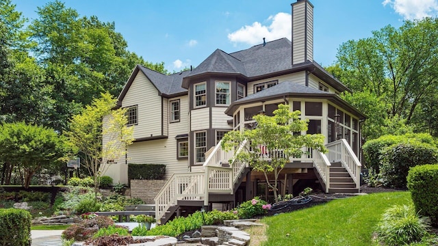 108 Hawks Cove Ct, Granville, OH 43023 - rear view of property featuring stairway, a sunroom, a chimney, and a shingled roof