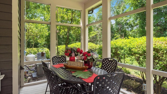 108 Hawks Cove Ct, Granville, OH 43023 - sunroom with outdoor dining area, plenty of natural light, and view of wooded area