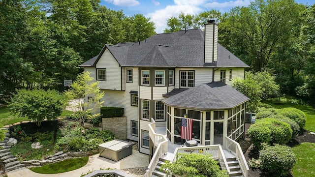 108 Hawks Cove Ct, Granville, OH 43023 - rear view of house featuring a sunroom, a shingled roof, a wooden deck, a chimney, and stairway