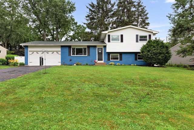 966 Larkstone Dr, Columbus, OH 43235 - tri-level home featuring an attached garage, asphalt driveway, a front lawn, and brick siding